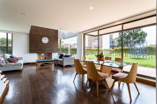 Free Spacious living and dining area with glass windows and modern furnishings. Stock Photo