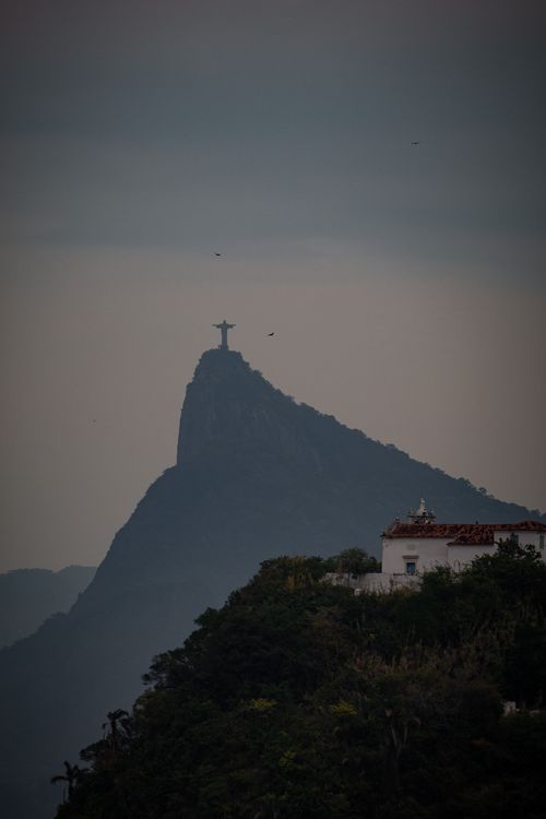 Free Silhouette of Christ the Redeemer statue at dusk, iconic symbol of Rio de Janeiro, Brazil. Stock Photo