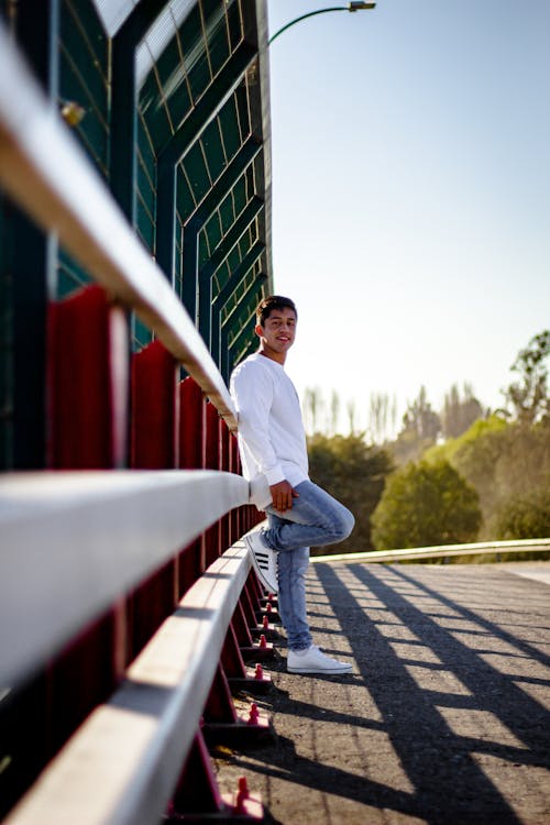 Man in White Long Sleeve Shirt Standing on Street