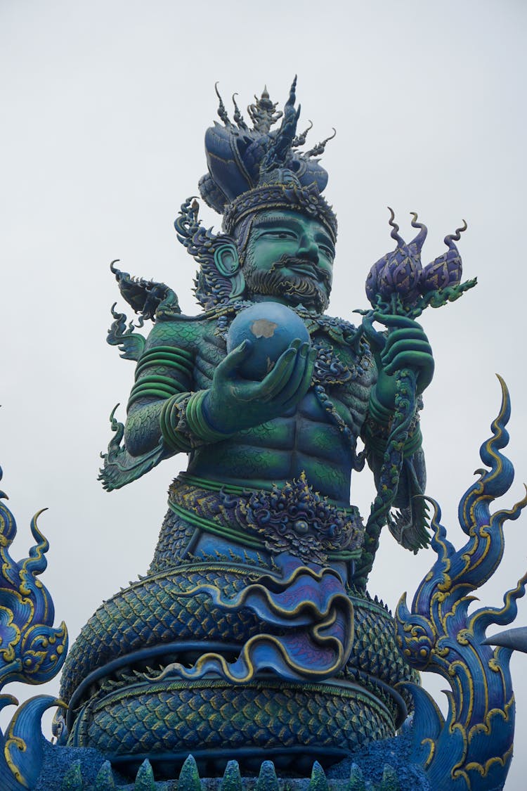 Low Angle Shot Of A Statue In Wat Rong Suea Ten, Buddhist Temple In Chiang Rai, Thailand