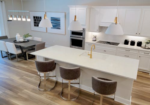 Spacious and luxurious kitchen with modern design and dining table setup, perfect for stylish interiors.