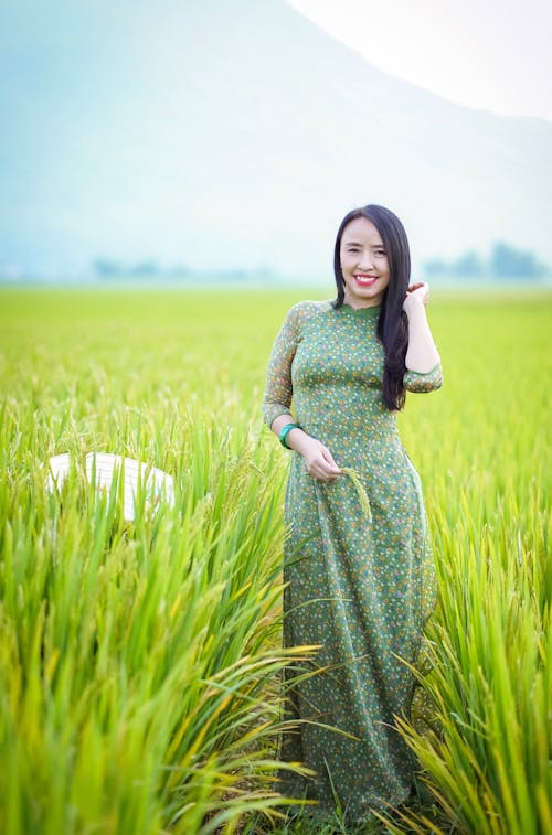 Woman in Green Dress Standing in the Field