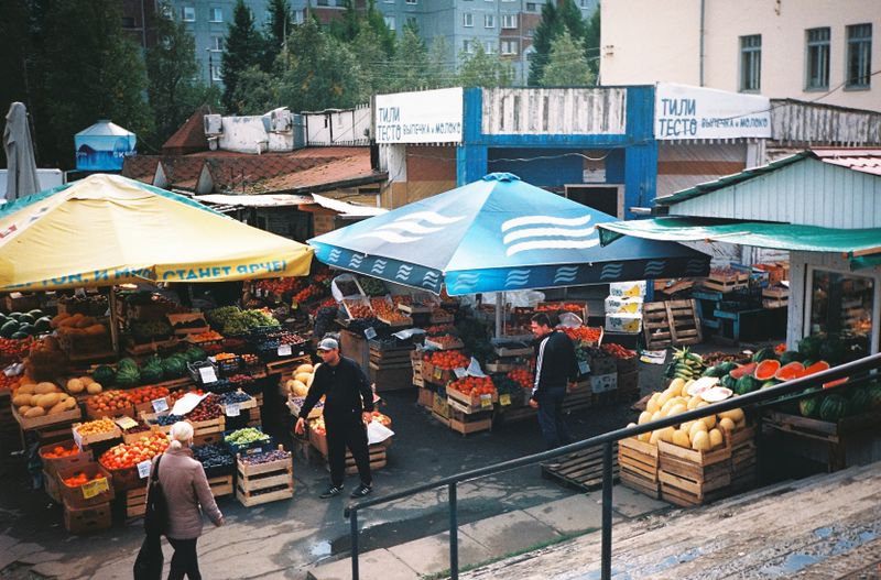 Illustrative produce stalls at an open-air farmers market; not Orlando Farmers Market