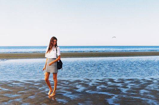 Woman Standing Barefoot on Shore