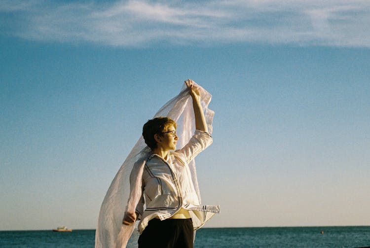 Woman Holding White Scarf Under Sea