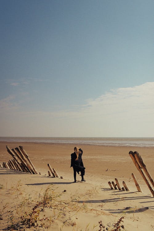 Woman Standing on Beach and Looking at Sea