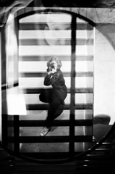 Artistic black and white self-portrait reflection captured on stairs using creative angles.