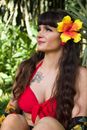 Woman in Red Tank Top With Yellow Flower on Ear