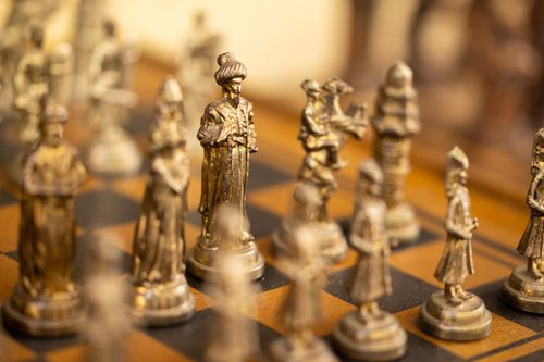 Free Close-up of ornate chess pieces depicting historical figures on a chess board. Stock Photo