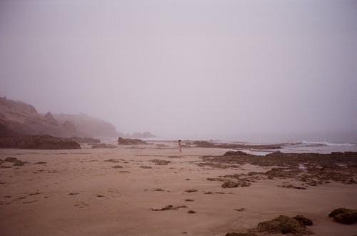 Child on Beach under Fog