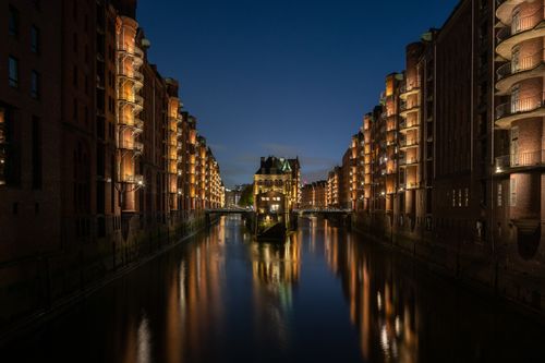 Free Beautiful night view of Hamburg's Speicherstadt reflecting in a canal, Germany. Stock Photo