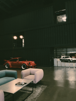 Elegant car showroom in Dubai featuring luxury sports cars and contemporary furniture.