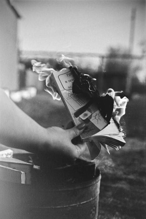 Woman Holding Burning Book