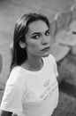 Grayscale Photo of a Woman in White Shirt