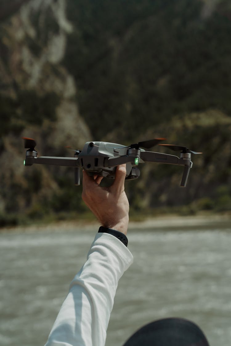 A Person Holding A Drone Ready For Take Off