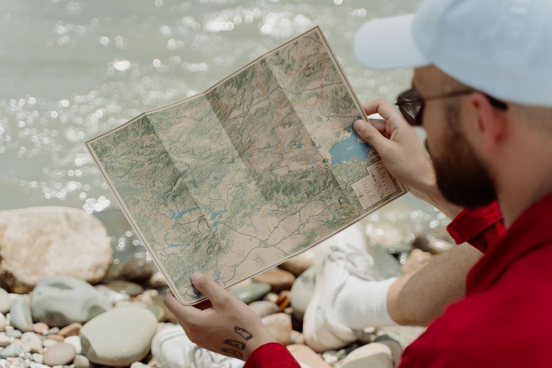 Top View Man Map A Man Looking at a Map · Free Stock Photo