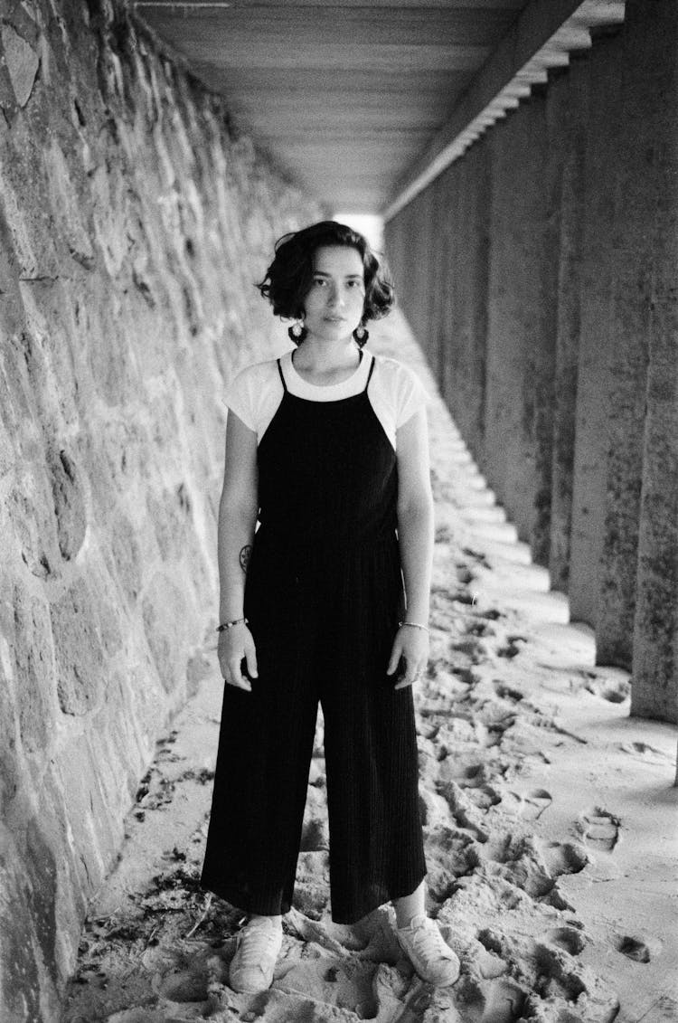 Young Woman Under A Pier On The Beach 