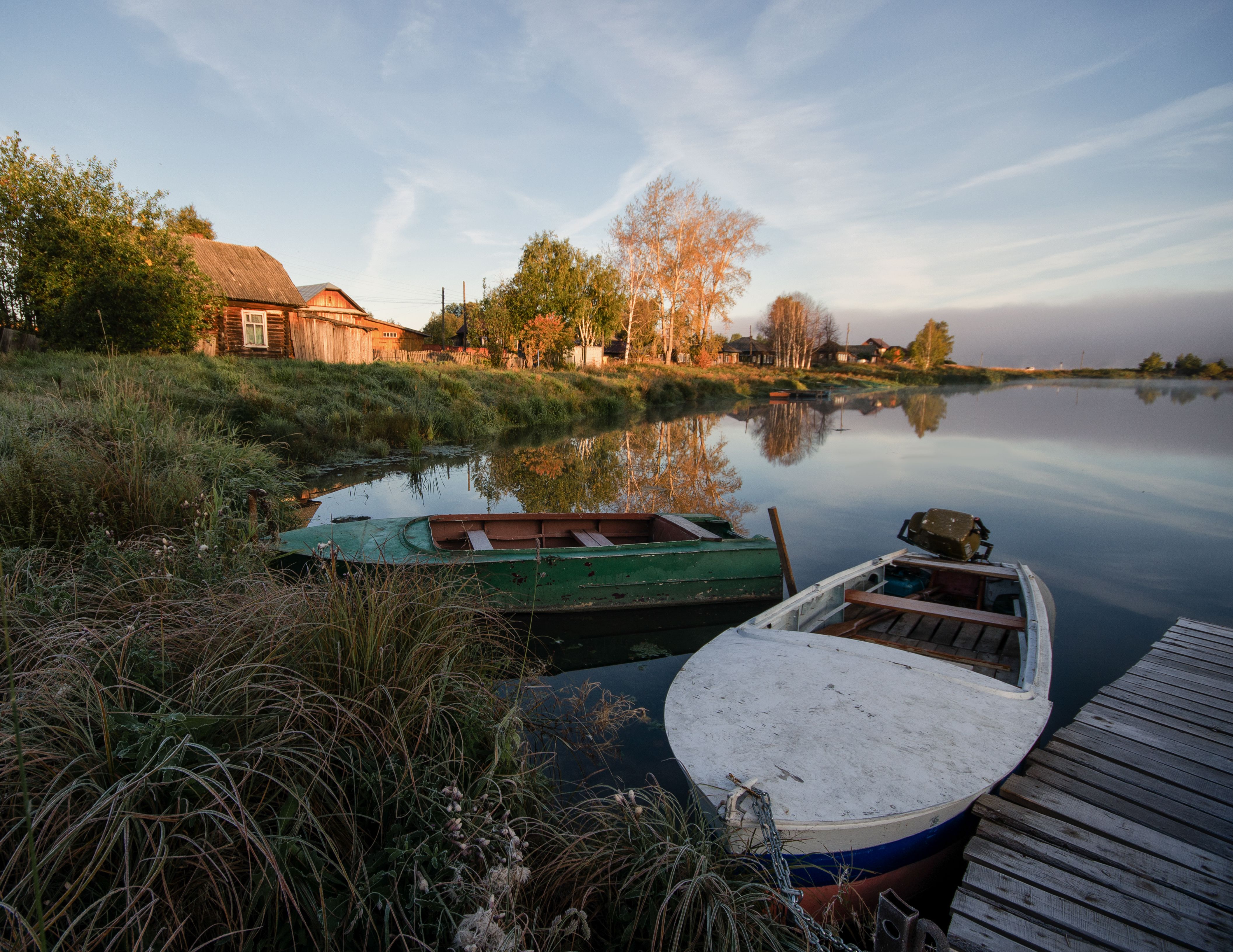 wooden boat, lakeshore water, calm lake, sunset light