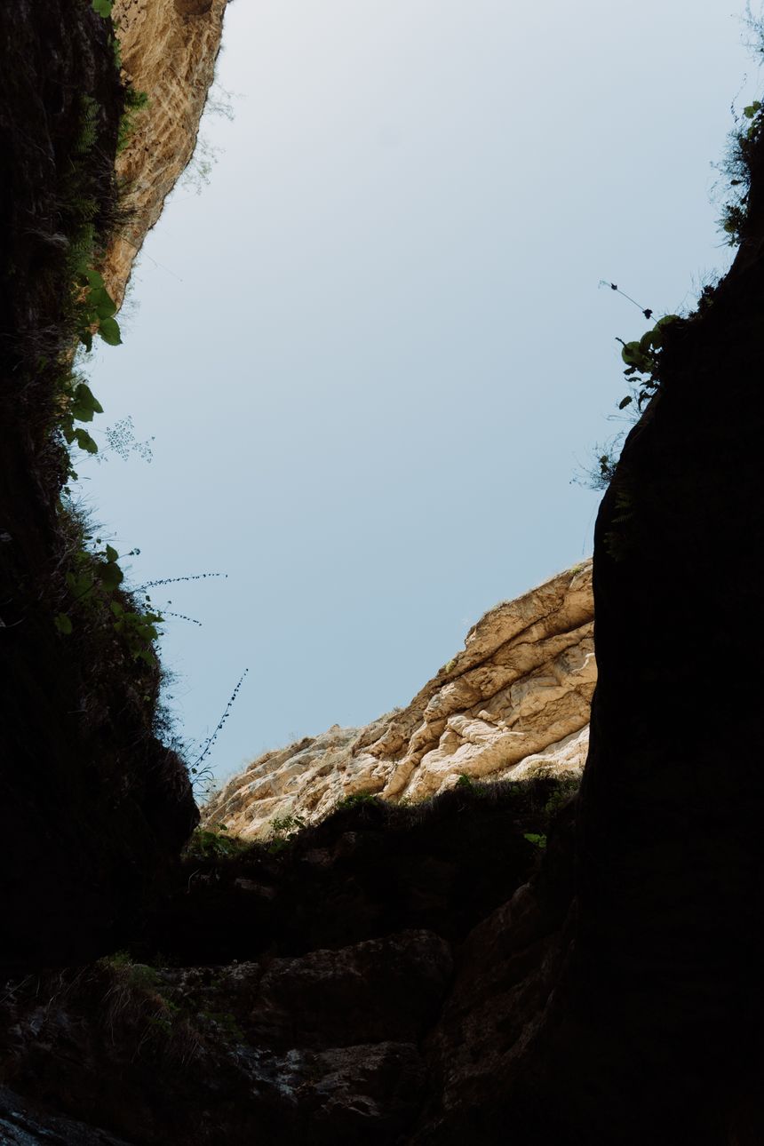 Rock walls of a narrow canyon framing the sky, photo by cottonbro studio on Pexels