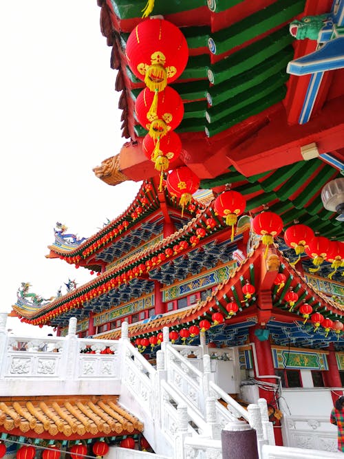 Red Lanterns Hanging on Colorful Temple Roofing
