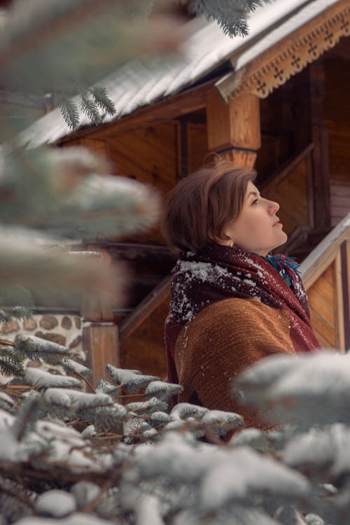 Woman Wearing a Scarf Standing Near a Staircase