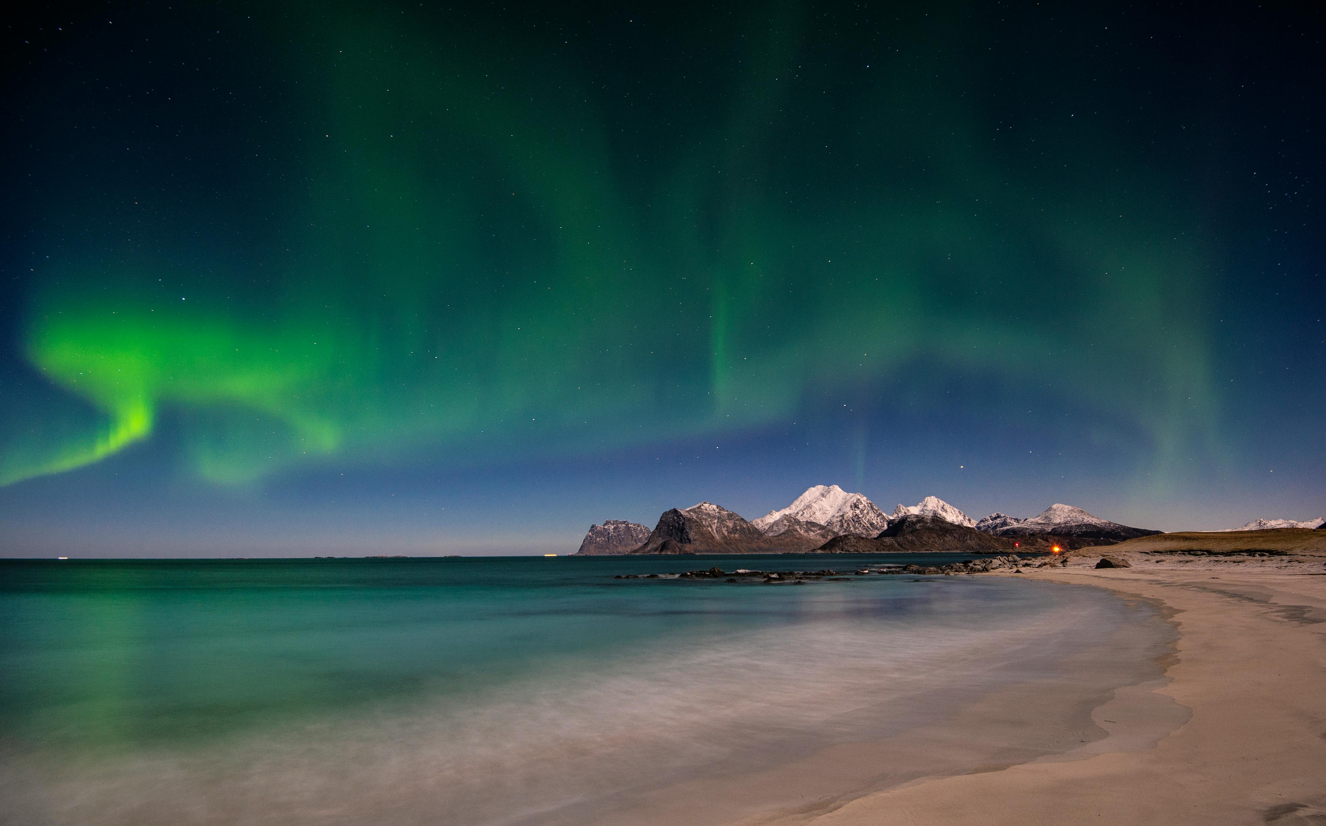 Prescription Goggle Inserts - Stunning view of aurora borealis illuminating the night sky over a snowy beach in Nordland, Norway.