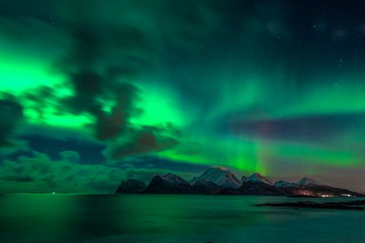 Captivating view of the Aurora Borealis over Storsandnes, Norway, showcasing natural beauty.