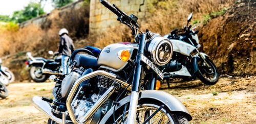 Free Close-up of a classic motorcycle parked outdoors with other bikes, conveying adventure and freedom. Stock Photo