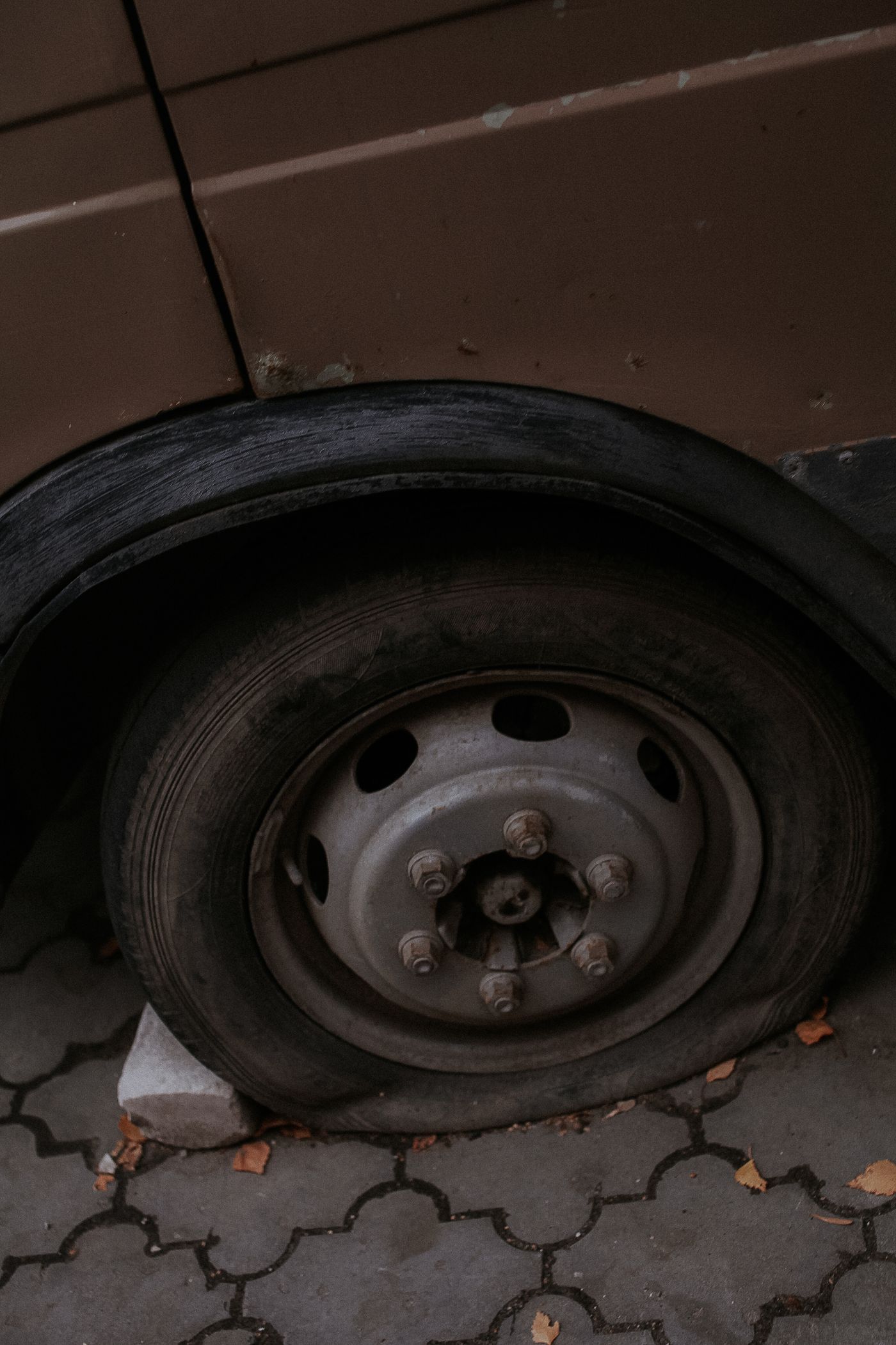 Close-up of a flat tyre on the roadside