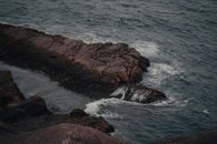 Gentle Sea Waves Bouncing off Basalt Rocks at Sea Shore