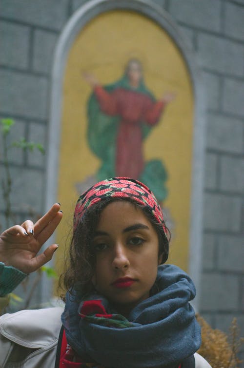 Woman Wearing a Headscarf Flashing the Peace Sign