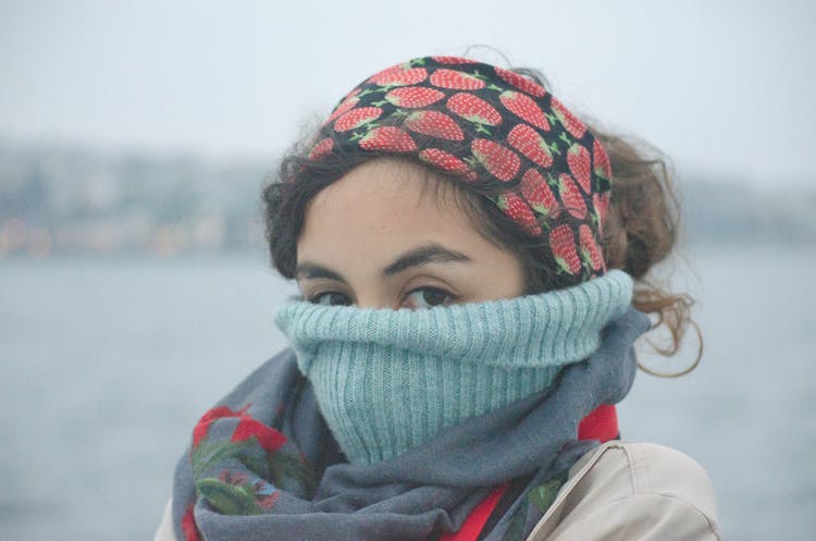 Woman Covering Face With Scarf