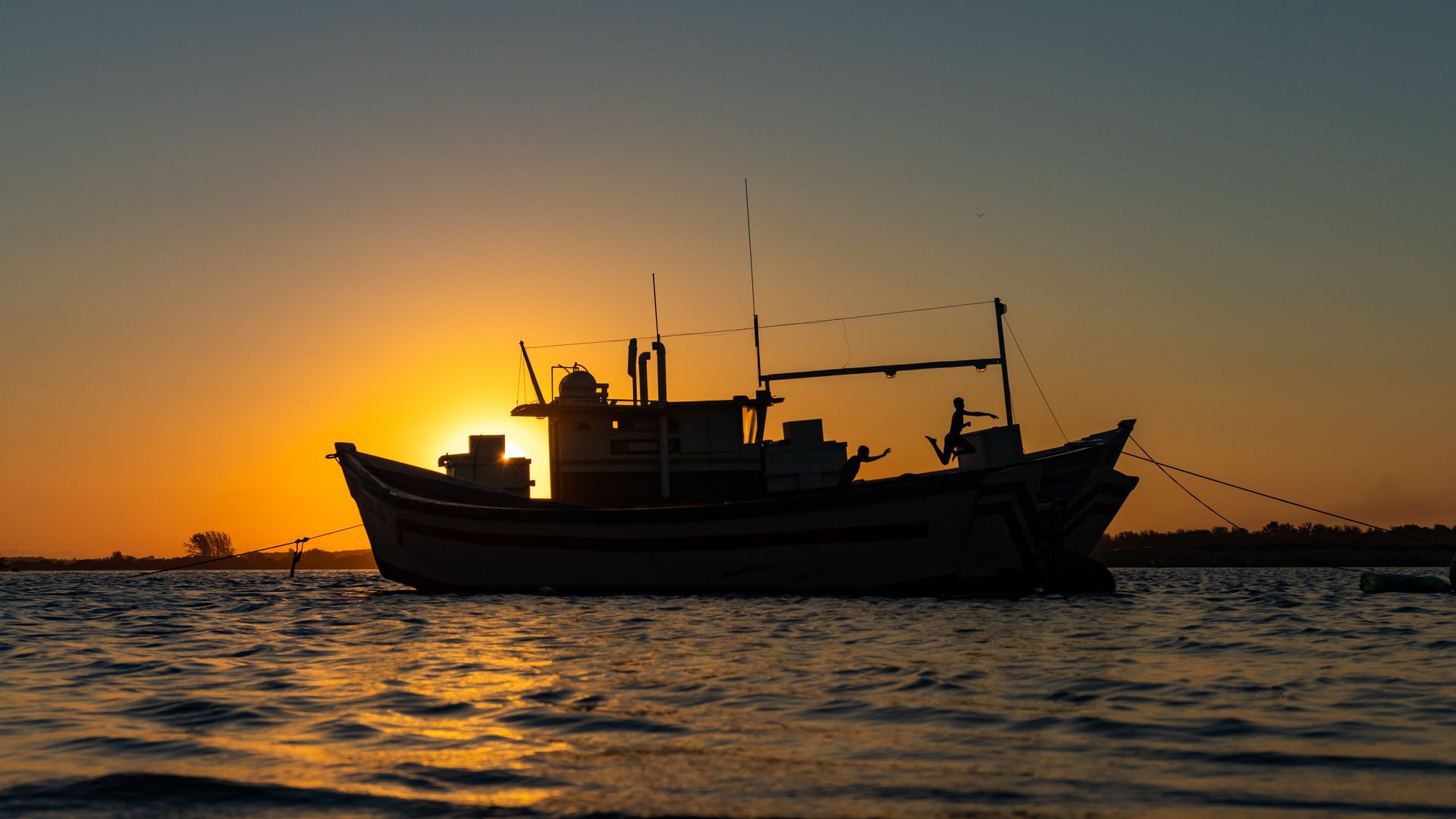 Atlantic Ocean fishing boat at sunset
