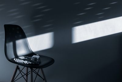Black chair with unique lighting pattern creating a minimalist and moo — Photo by HamZa NOUASRIA on Pexels