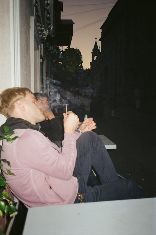Man Wearing Purple Sweater Smoking Cigarette 