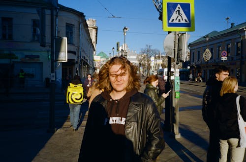 A Man in Black Leather Jacket Standing on the Street