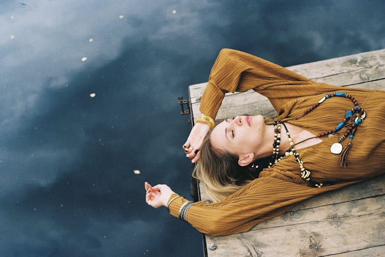 Woman Lying On Wooden Platform