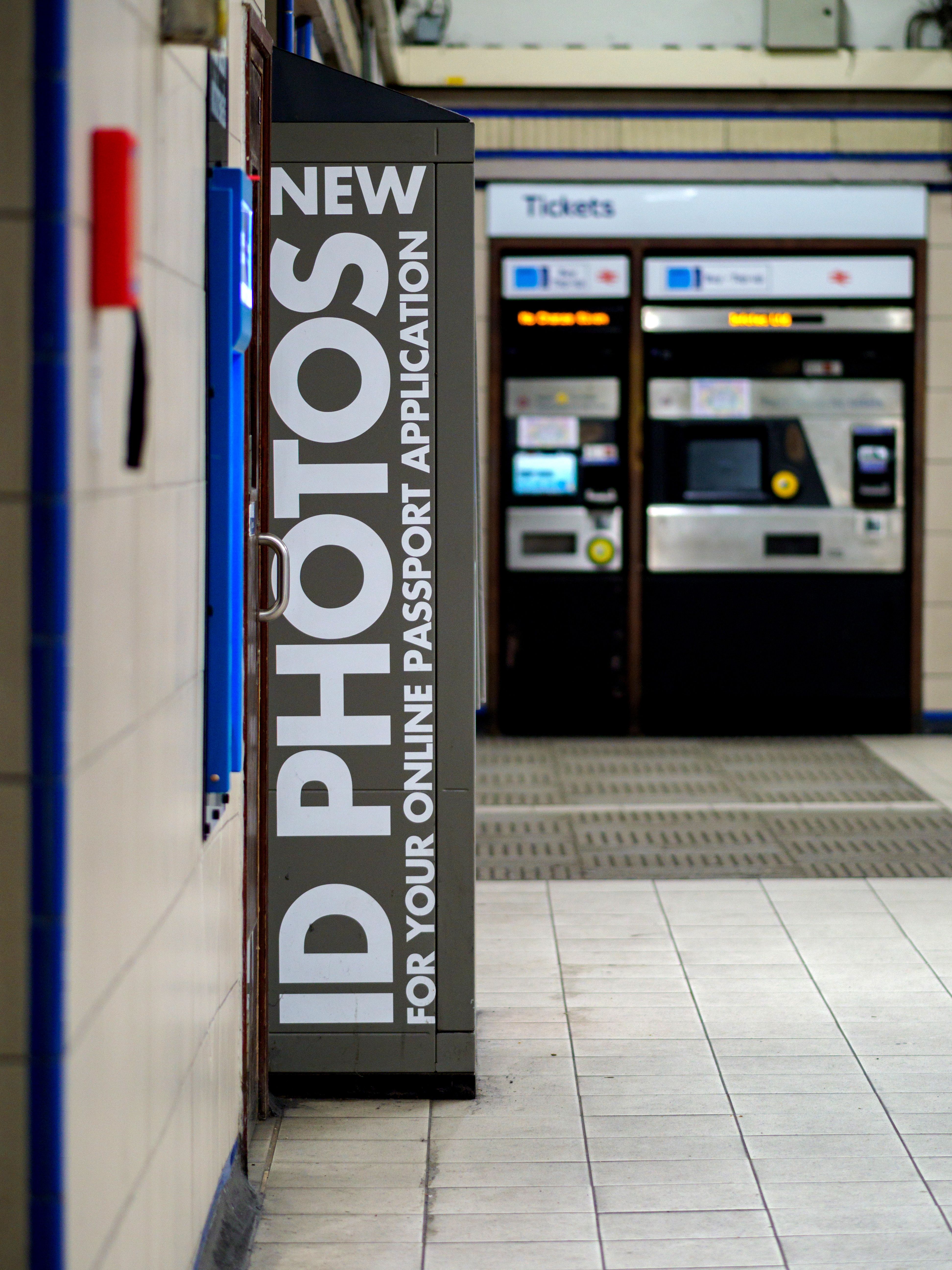 Urban subway scene with ID photo booth and ticket machine in London station