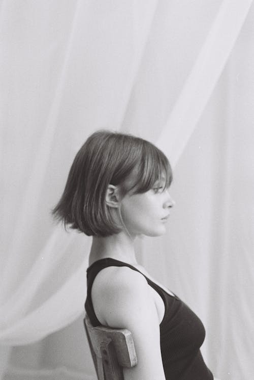 Woman with Short Hair Sitting on Chair