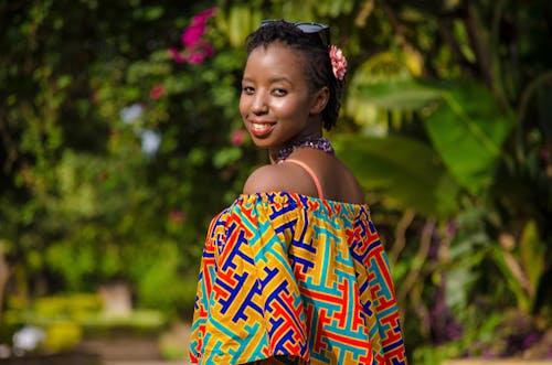 Shallow Focus Photography of Woman Wearing Multicolored Off-shoulder Top