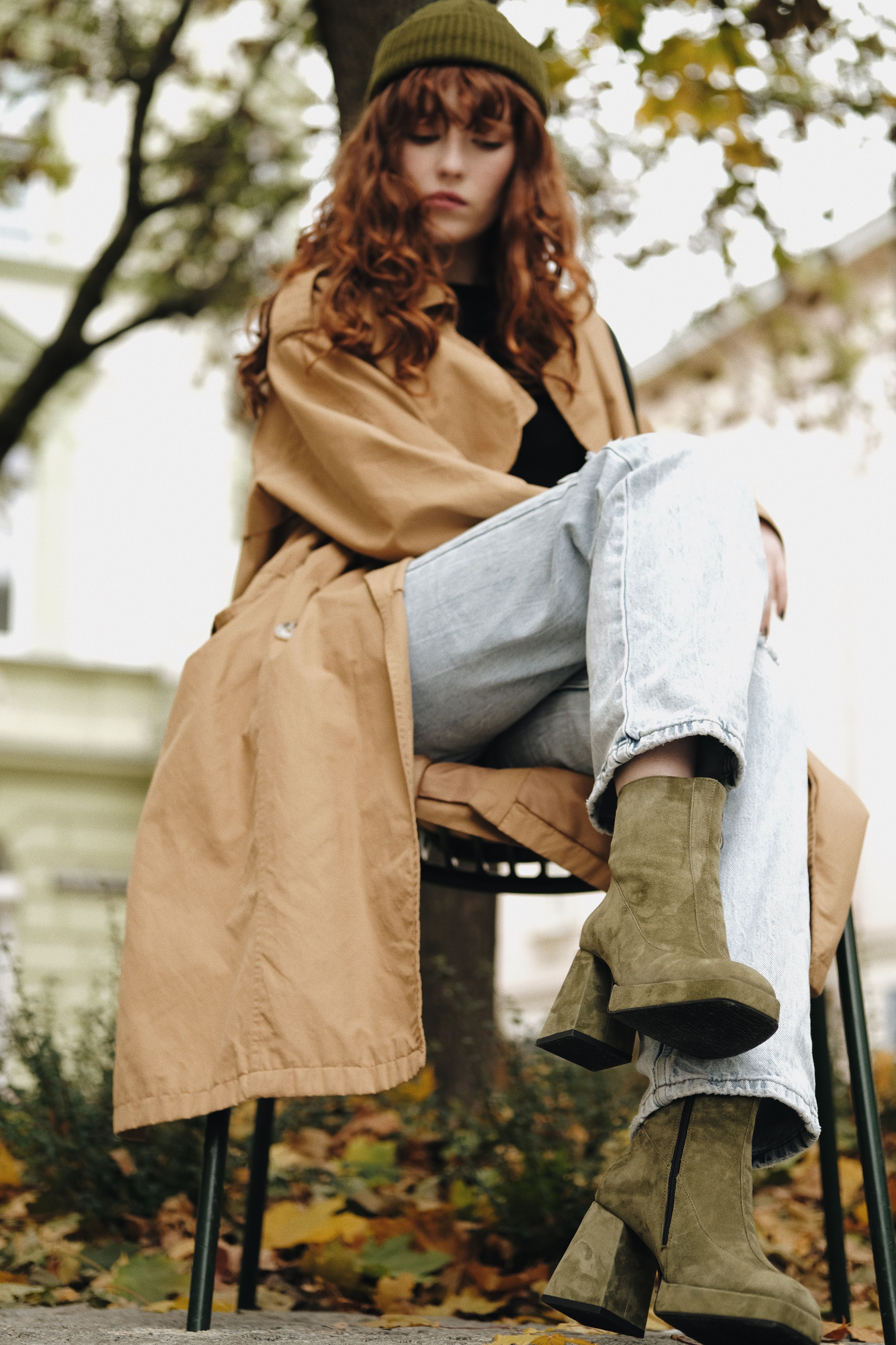 A Woman in Brown Coat Sitting on Brown Wooden Chair · Free Stock Photo