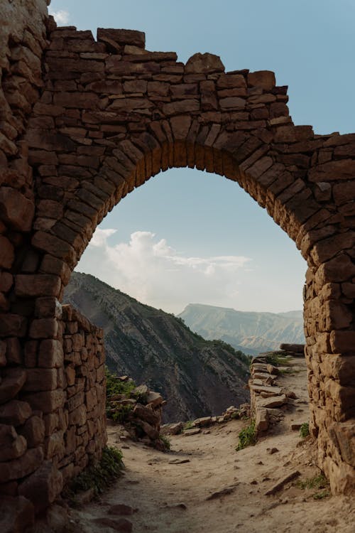 Scenic View of Mountain Ranges From an Arched Entrance