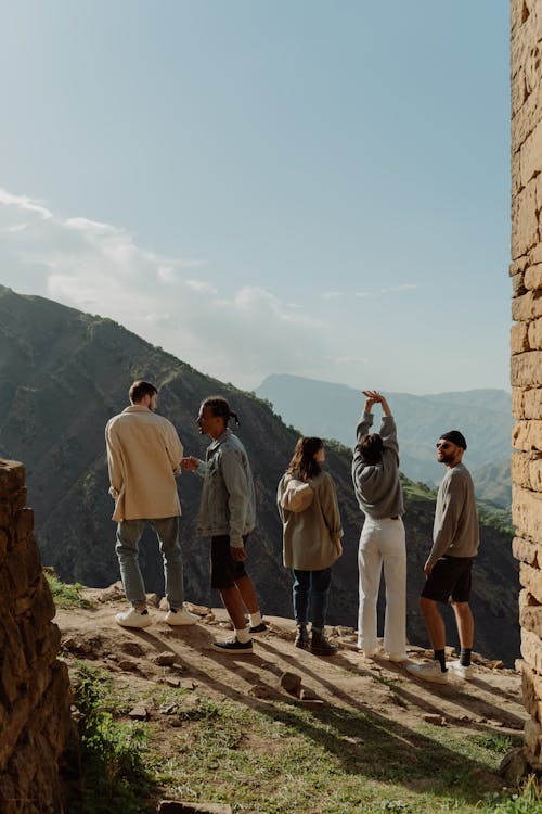 Group of People Standing on the Mountain Ranges