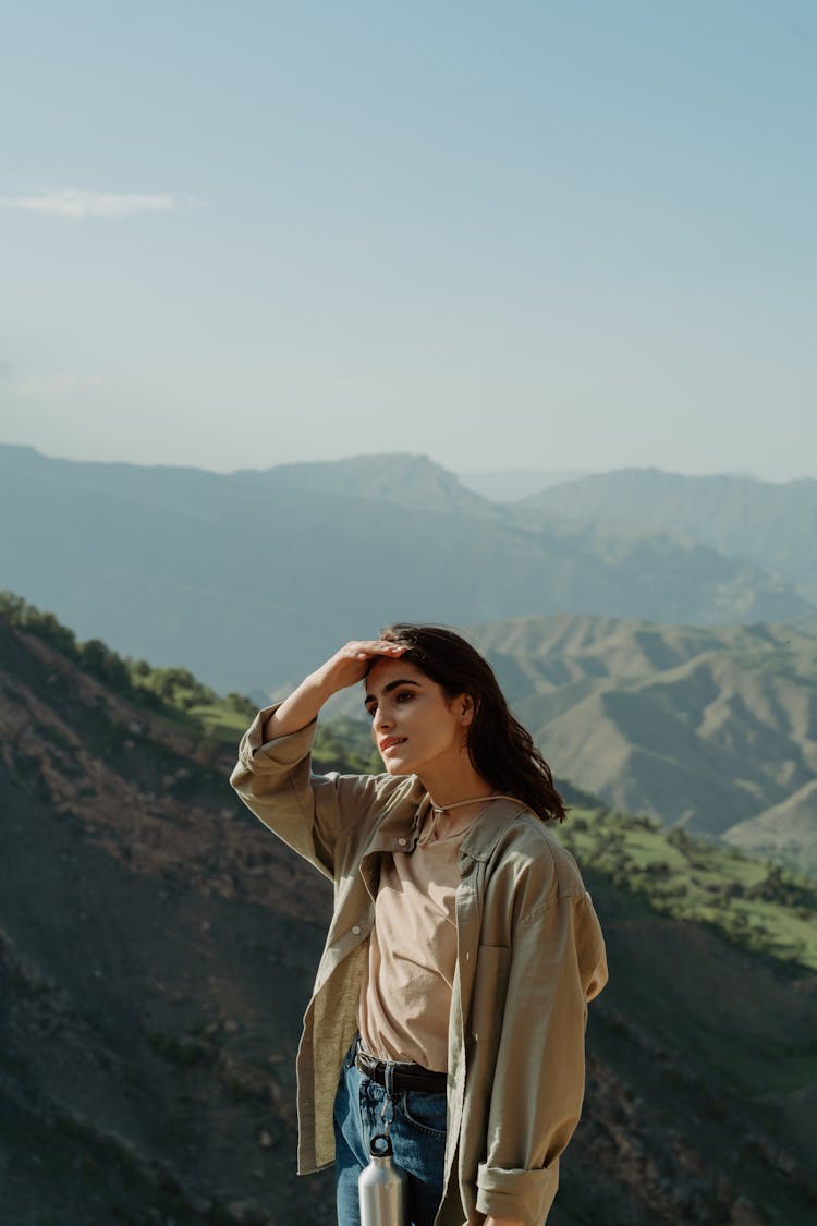 A Woman In  Long Sleeves Shirt Enjoying The Outdoors