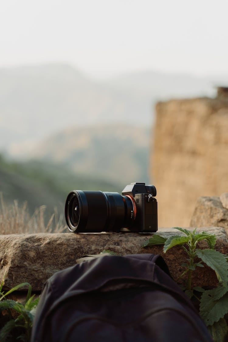 A Black Digital Camera Over A Rock