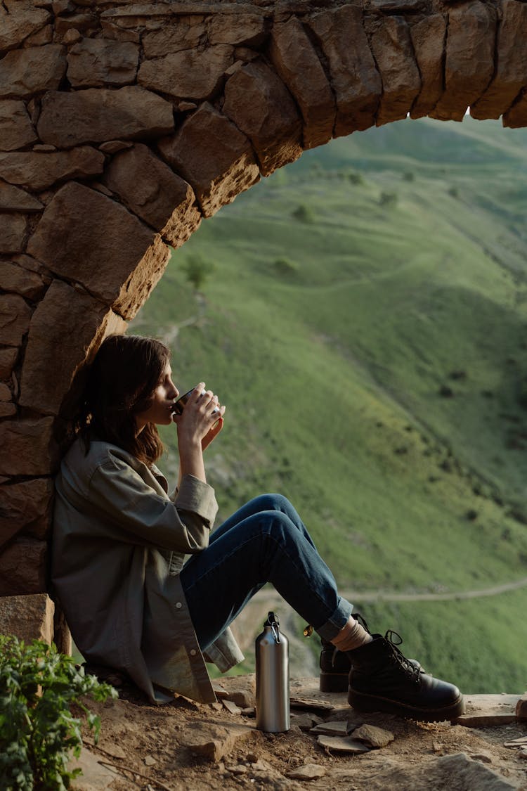 A Woman Drinking While Sitting Alone