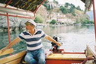 Boatman Steering Boat Through Water
