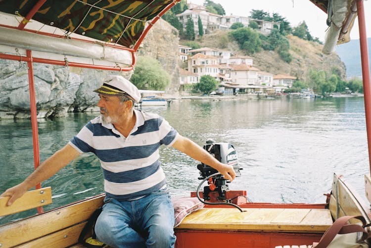 Boatman Steering Boat Through Water