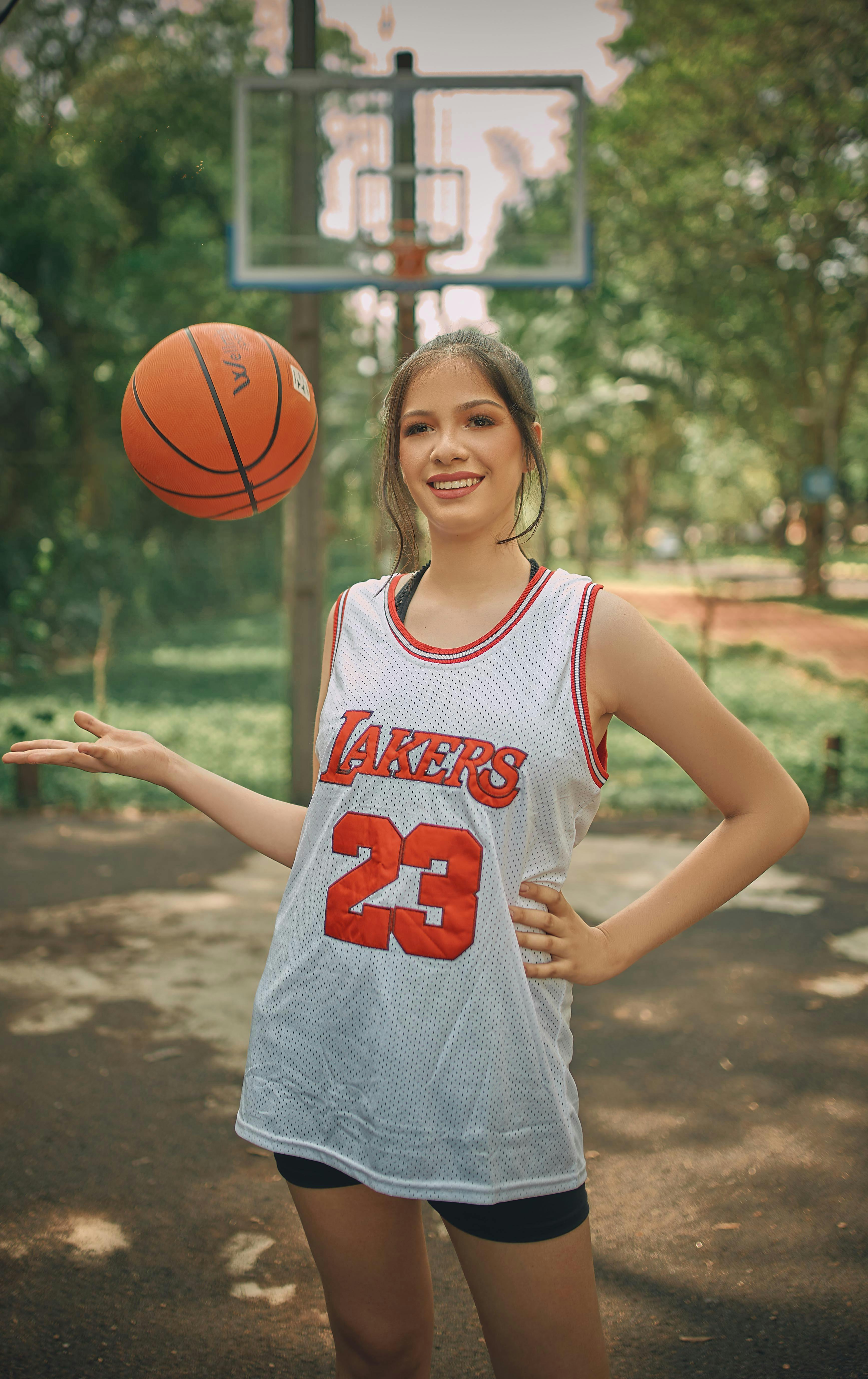 Free Woman in LA Lakers T-shirt and with Basketball Ball Stock Photo