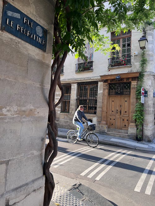 A Man Riding a Bicycle on the Street